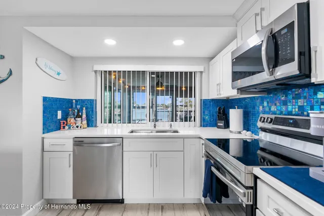 a kitchen with a stove microwave and sink
