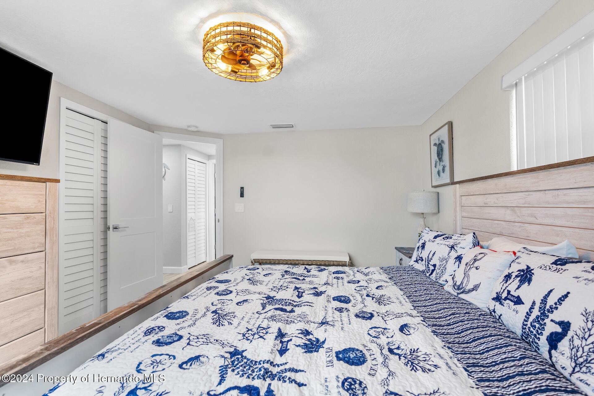 12535 3rd Isle Hudson, FL 34667 - Photo 25 of 46 a bedroom with a bed and a window