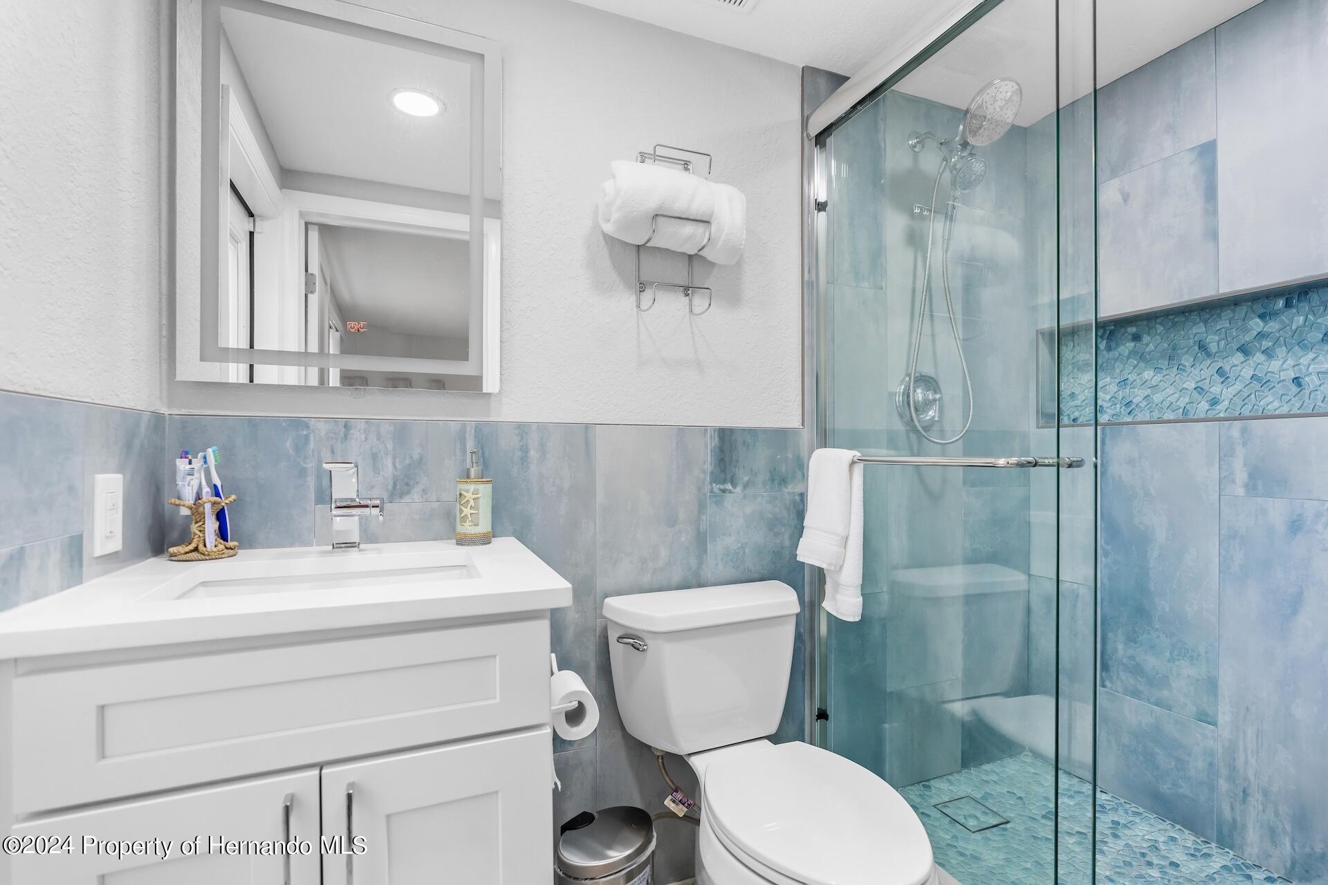 12535 3rd Isle Hudson, FL 34667 - Photo 26 of 46 a bathroom with a sink a toilet and shower