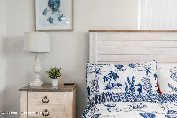 a view of a bedroom with wooden floor and bedroom space