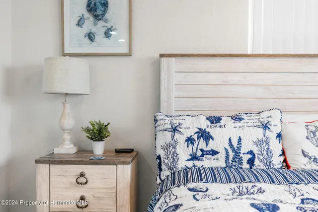 a view of a bedroom with wooden floor and bedroom space