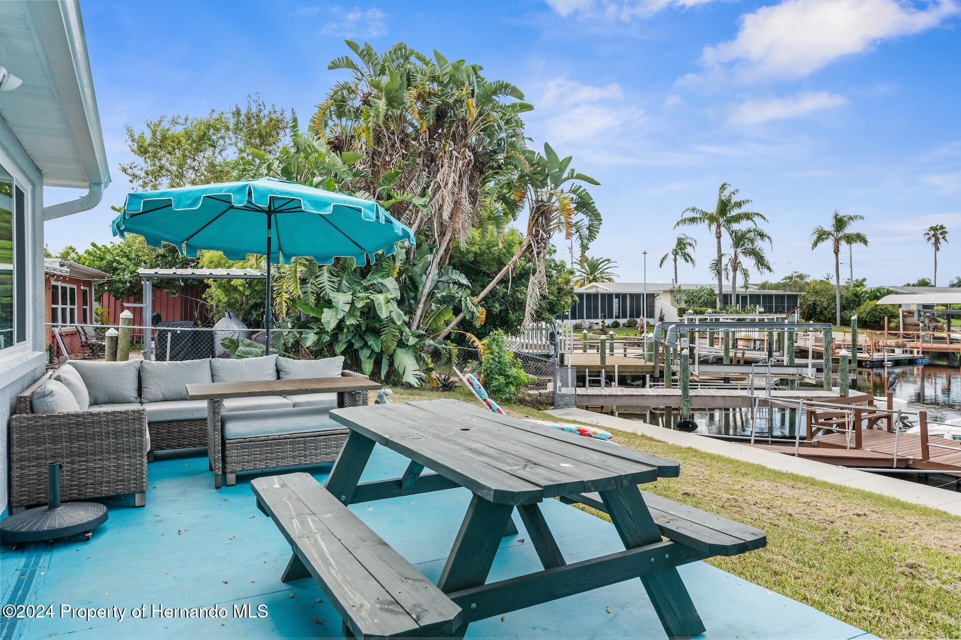 12535 3rd Isle Hudson, FL 34667 - Photo 37 of 46 a view of a swimming pool with a lounge chairs