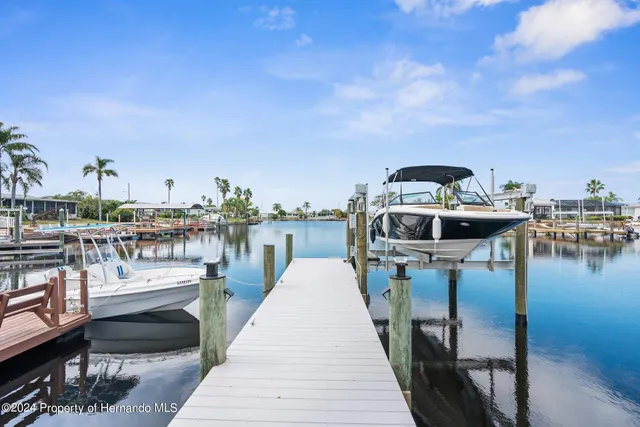 a view of swimming pool with outdoor seating and a garden