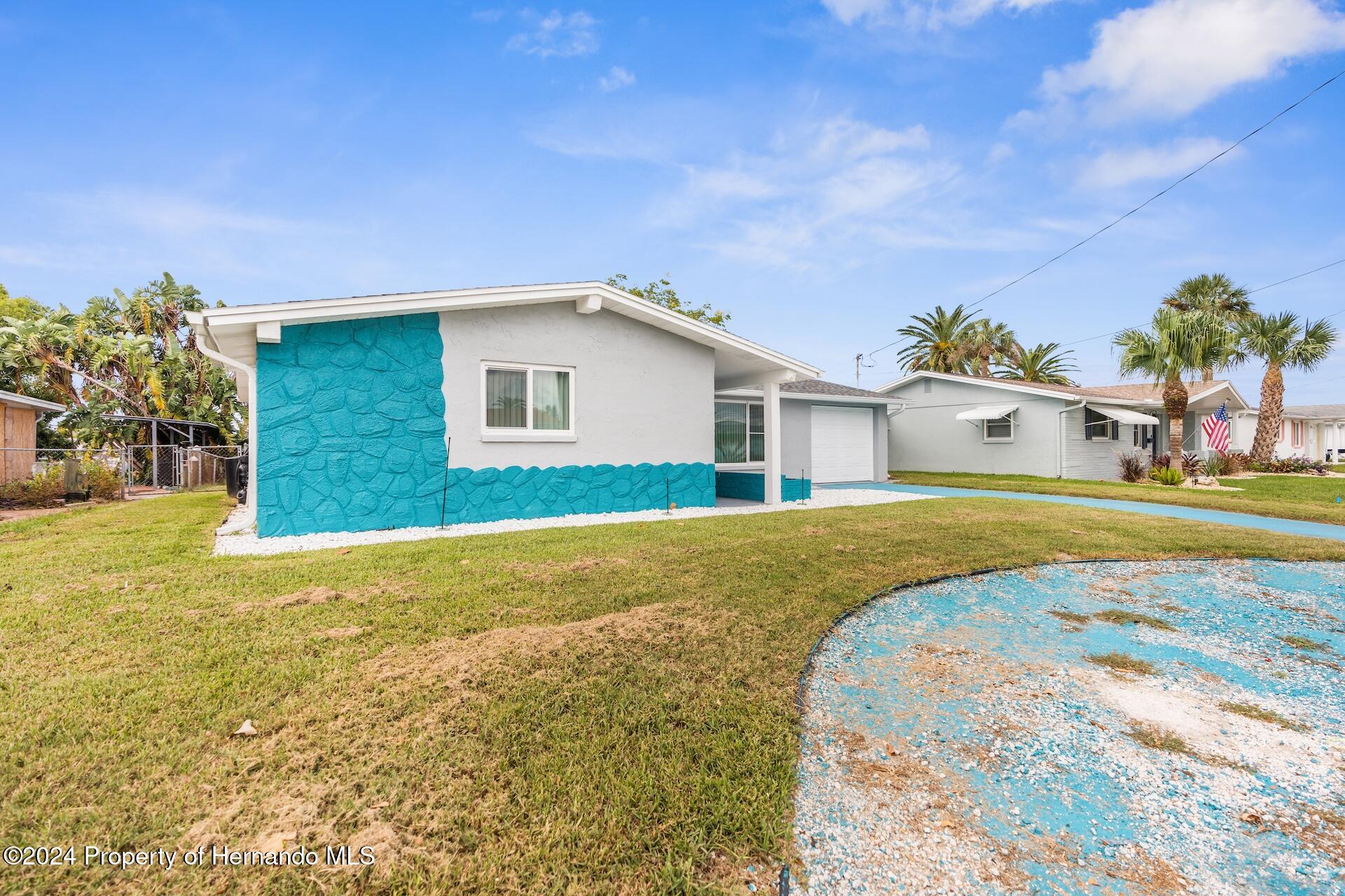 12535 3rd Isle Hudson, FL 34667 - Photo 10 of 46 a house view with a swimming pool