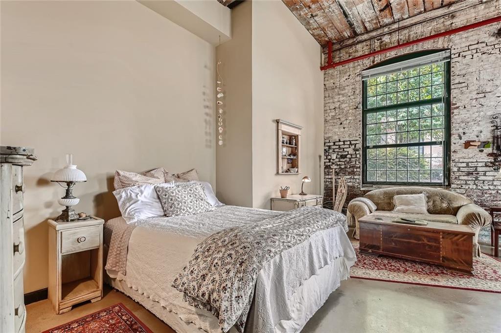 170 Boulevard Southeast, Unit 101F Atlanta, GA 30312 - Photo 5 of 11 a bedroom with bed couch and window