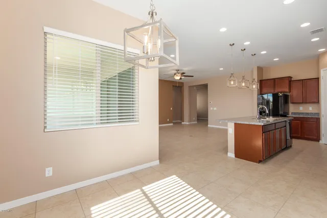a view of kitchen with stainless steel appliances kitchen island a refrigerator sink and a stove