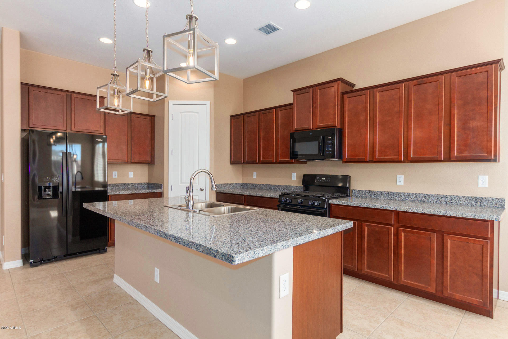 8642 Wandering Creek Road Prescott Valley, AZ 86315 - Photo 13 of 29 a kitchen with stainless steel appliances granite countertop a sink stove and refrigerator