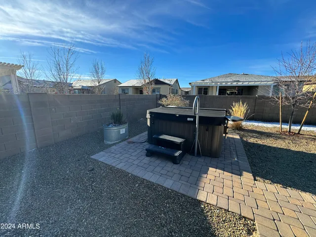 a view of a patio with table and chairs a barbeque