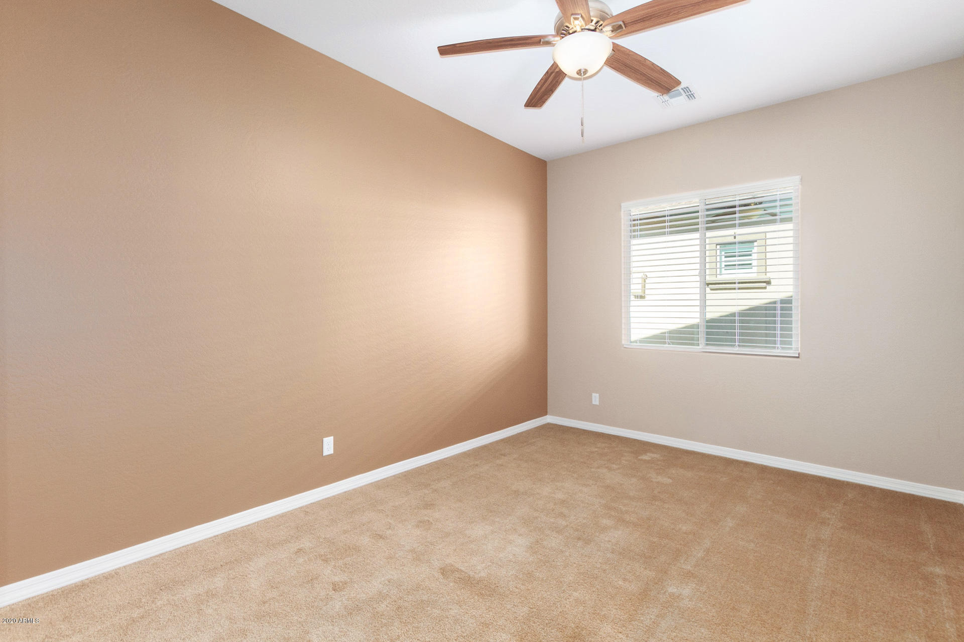 8642 Wandering Creek Road Prescott Valley, AZ 86315 - Photo 5 of 29 an empty room with a window and a fan