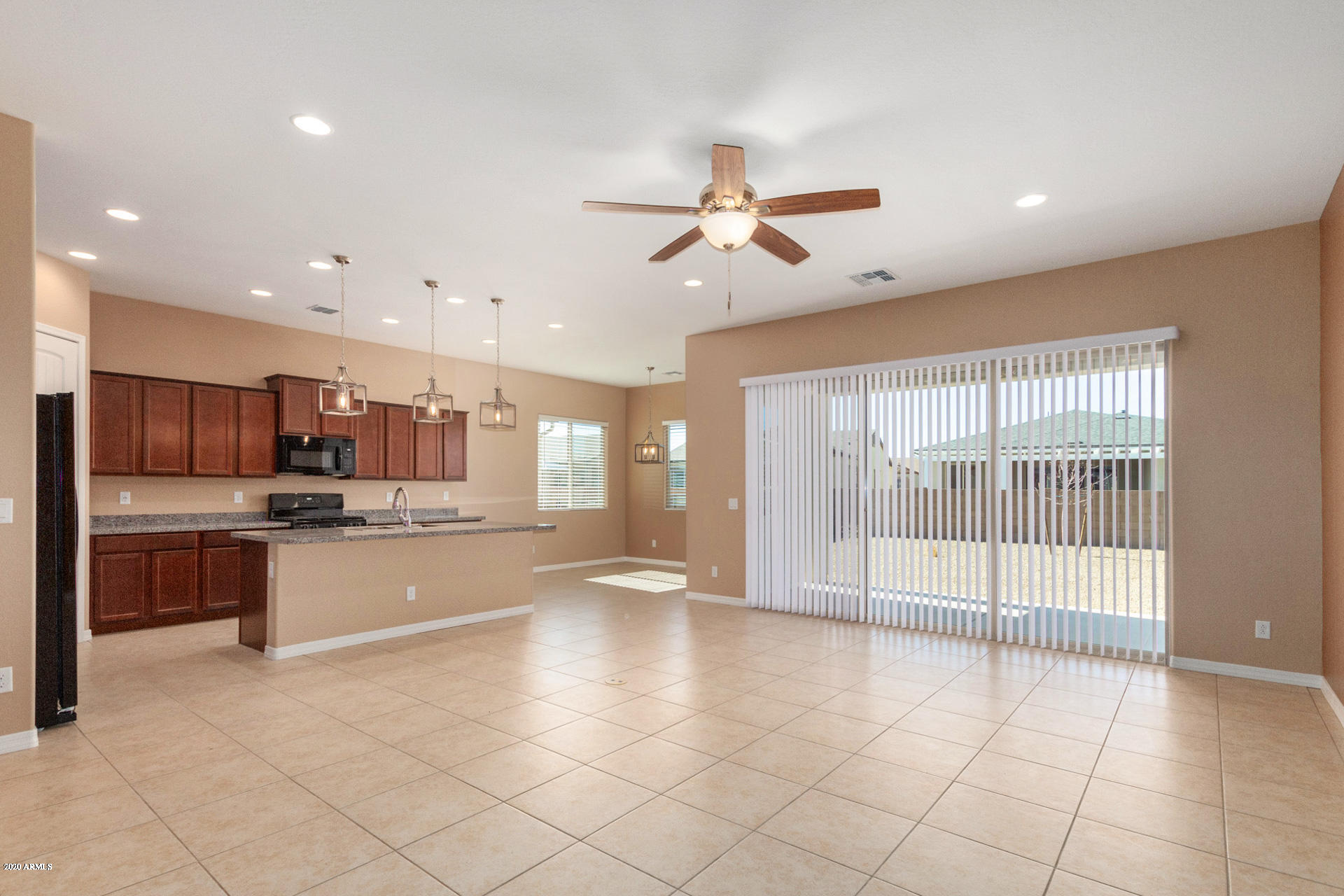 8642 Wandering Creek Road Prescott Valley, AZ 86315 - Photo 7 of 29 a large kitchen with kitchen island a large counter space a sink appliances and cabinets