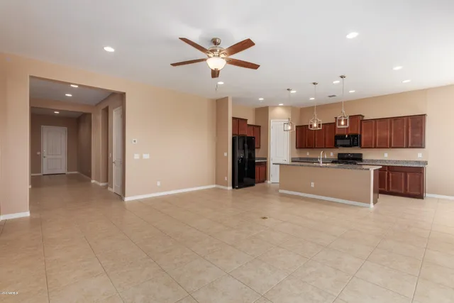 a view of kitchen with refrigerator and window