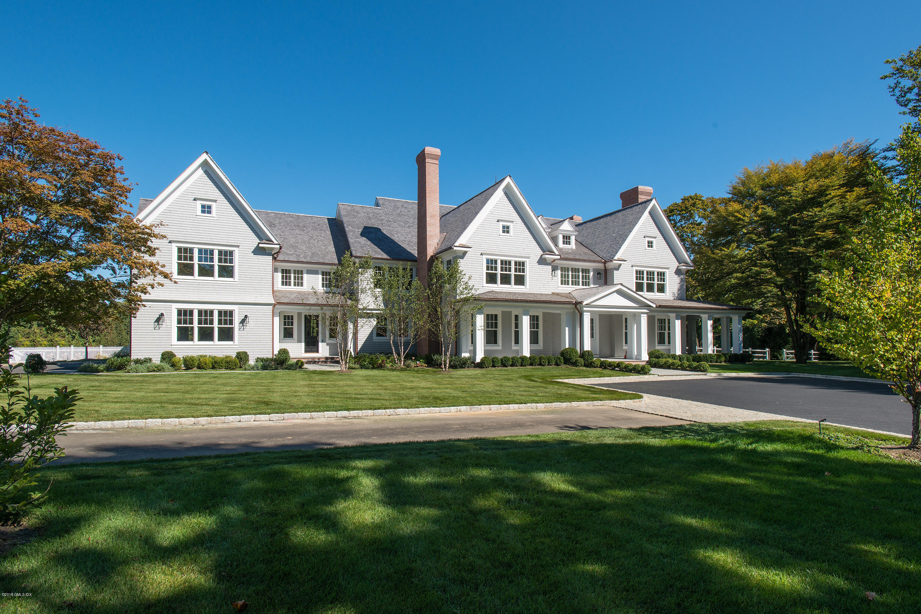 35 Mooreland Road Greenwich, CT 06831 - Photo 20 of 23 a front view of a house with a garden