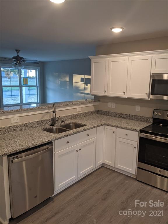 409 South Ridge Avenue Kannapolis, NC 28083 - Photo 11 of 13 a kitchen with granite countertop white cabinets and a sink