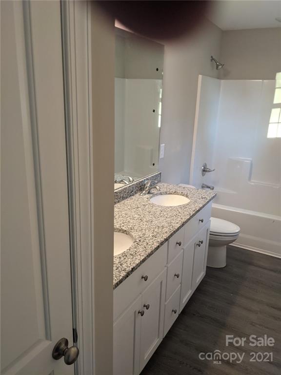 409 South Ridge Avenue Kannapolis, NC 28083 - Photo 5 of 13 a bathroom with a granite countertop sink and a mirror