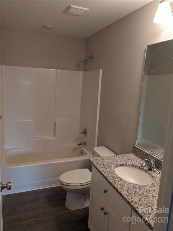 409 South Ridge Avenue Kannapolis, NC 28083 - Photo 6 of 13 a bathroom with a granite countertop sink a toilet and shower