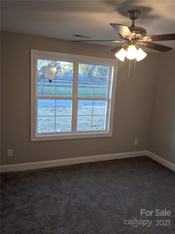 409 South Ridge Avenue Kannapolis, NC 28083 - Photo 9 of 13 en empty room with windows and chandelier