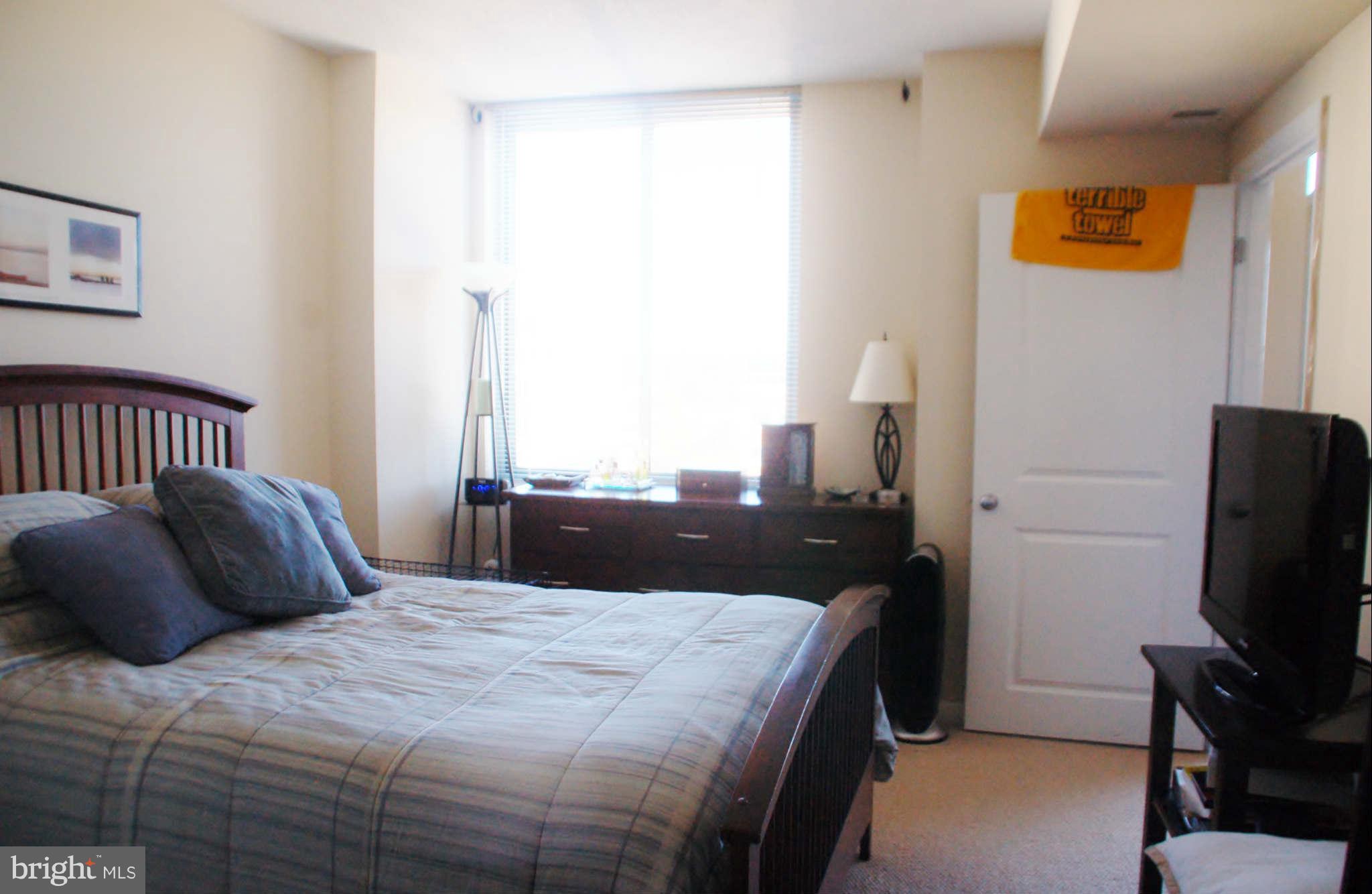 851 North Glebe Road, Unit 1015 Arlington, VA 22203 - Photo 13 of 19 a bedroom with a bed and flat screen tv