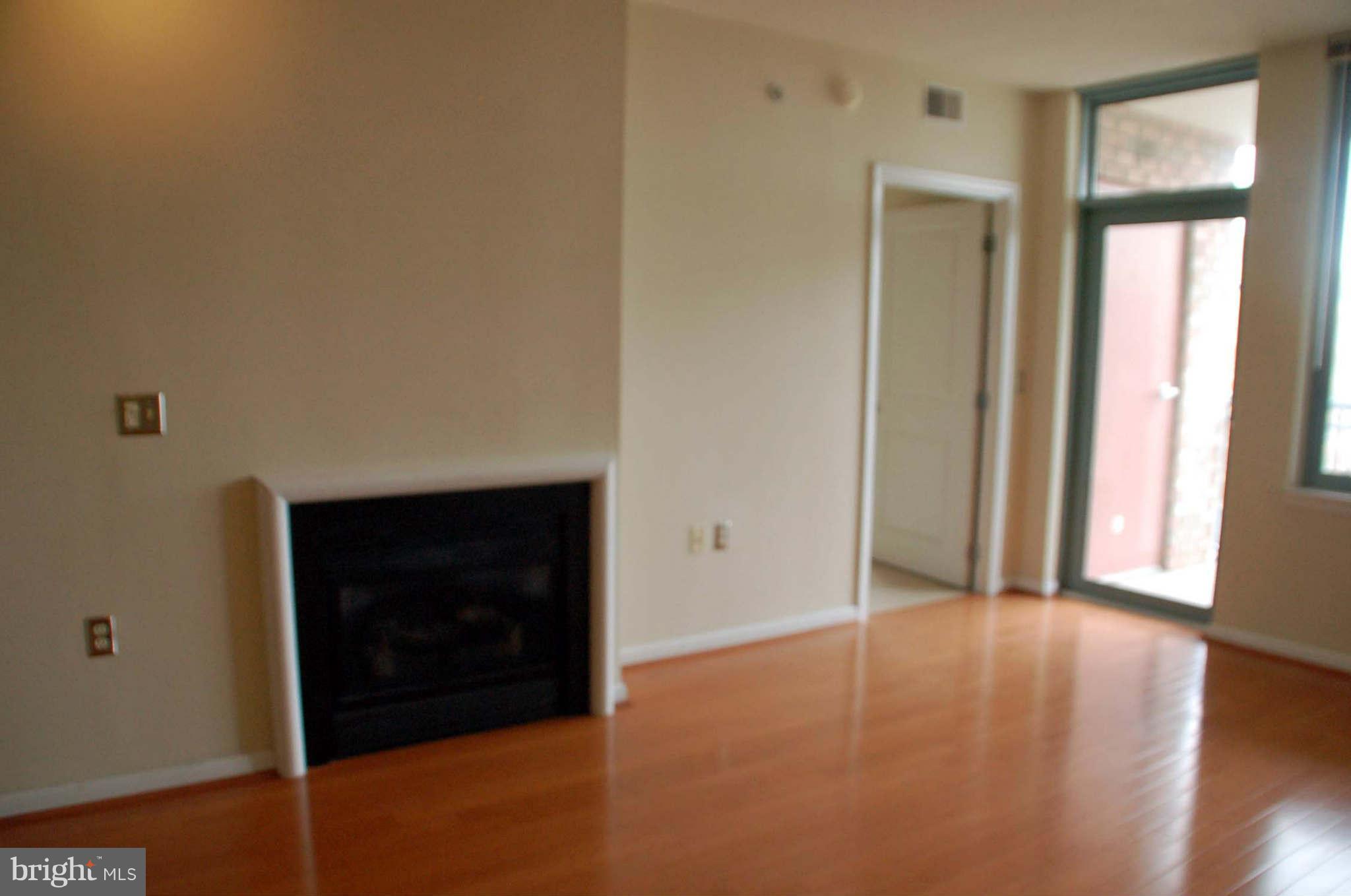 851 North Glebe Road, Unit 1015 Arlington, VA 22203 - Photo 10 of 19 a view of an empty room and window and wooden floor