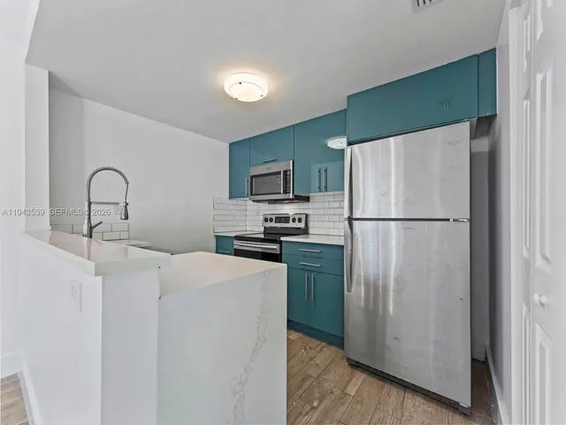 a kitchen with stainless steel appliances a refrigerator and a sink