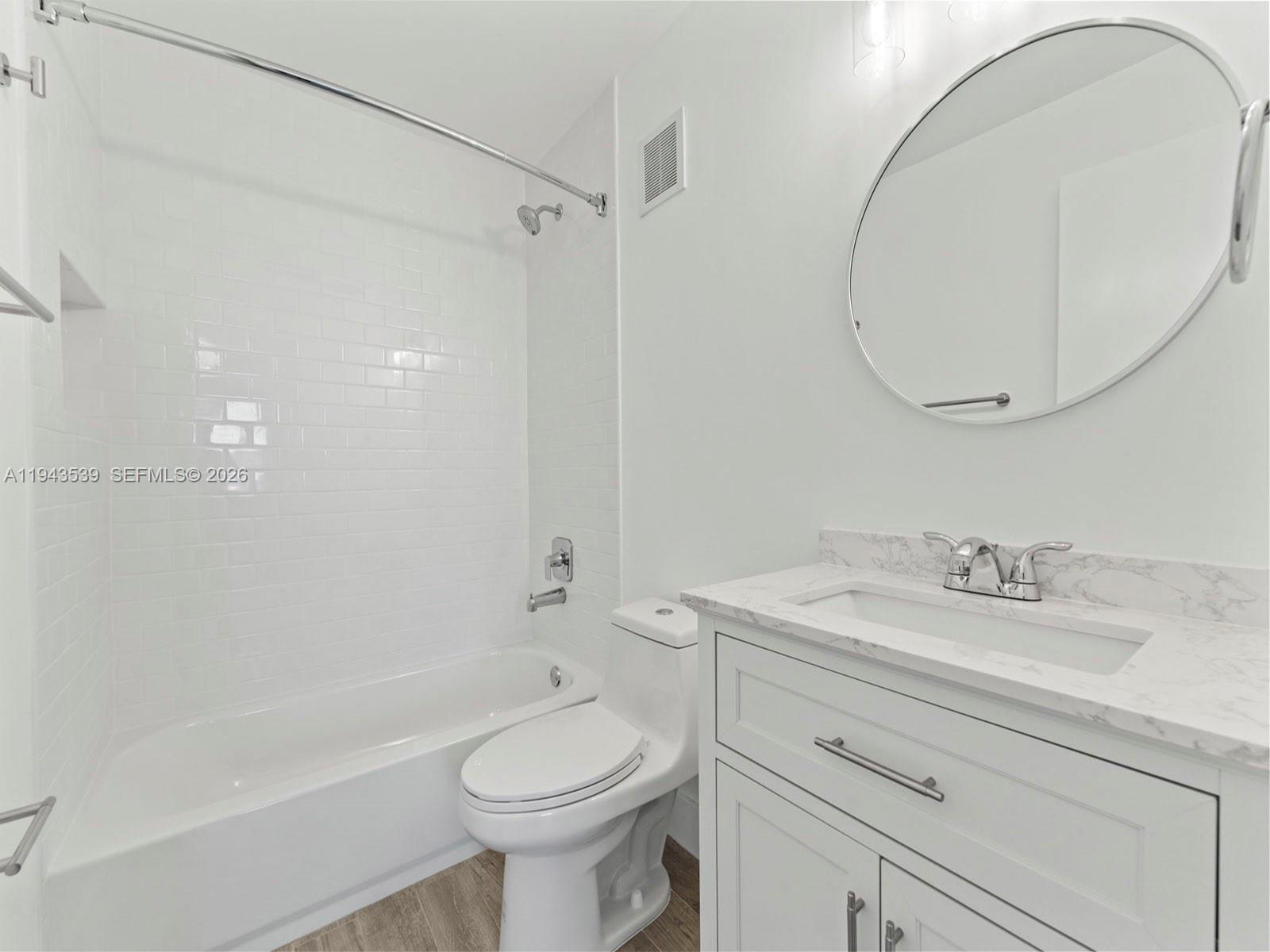 4560 Southwest 68th Ct Circle, Unit 619 Miami, FL 33155 - Photo 11 of 23 a bathroom with a sink a toilet and a mirror