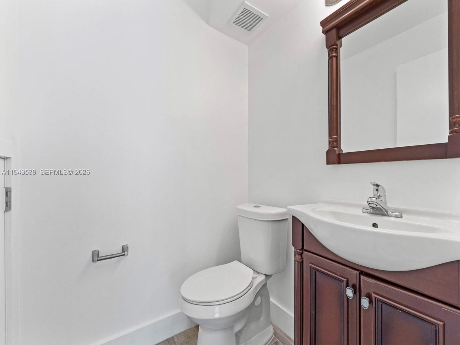 4560 Southwest 68th Ct Circle, Unit 619 Miami, FL 33155 - Photo 16 of 23 a bathroom with a sink toilet and mirror