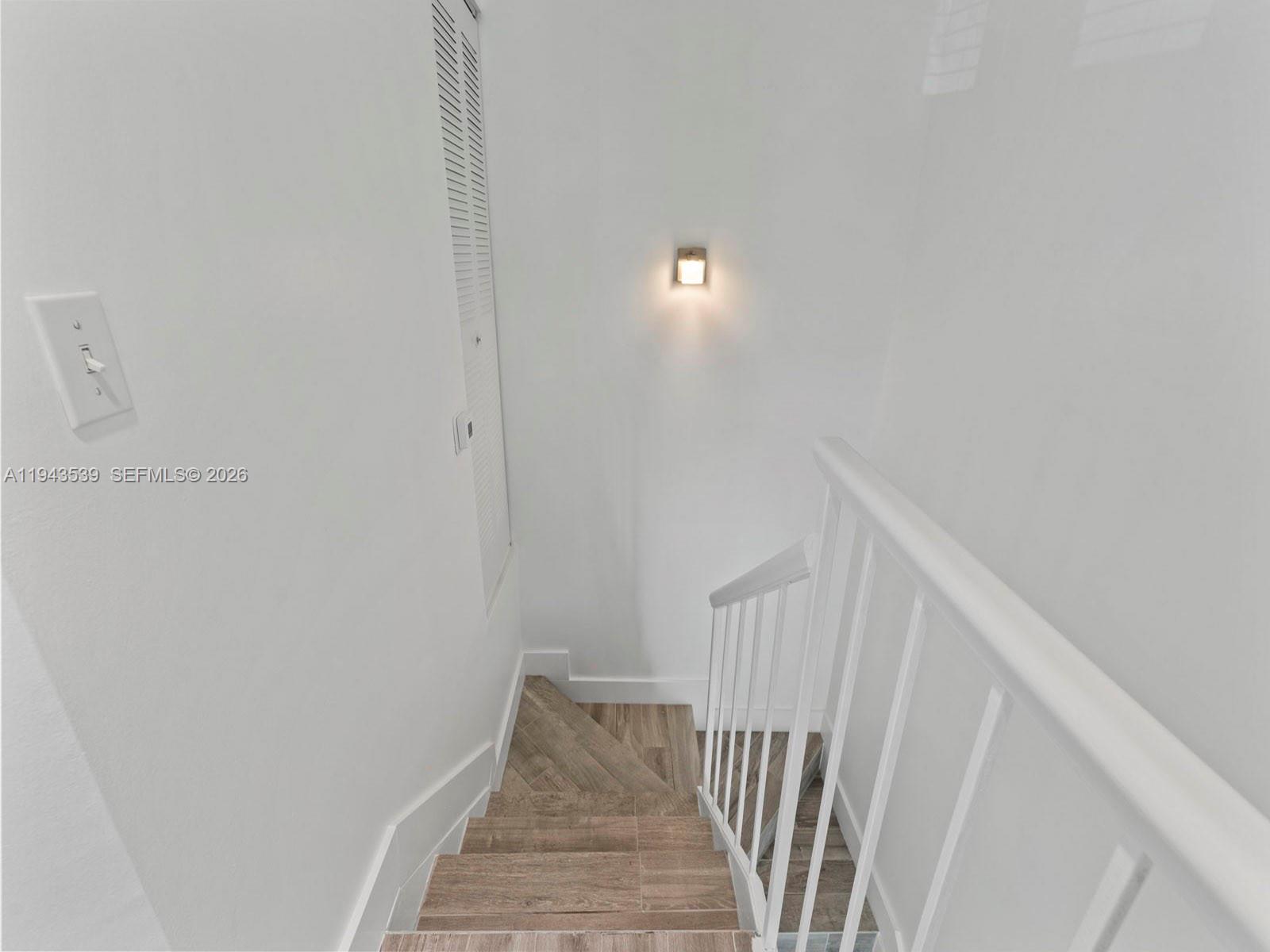 4560 Southwest 68th Ct Circle, Unit 619 Miami, FL 33155 - Photo 18 of 23 a view of a hallway with staircase