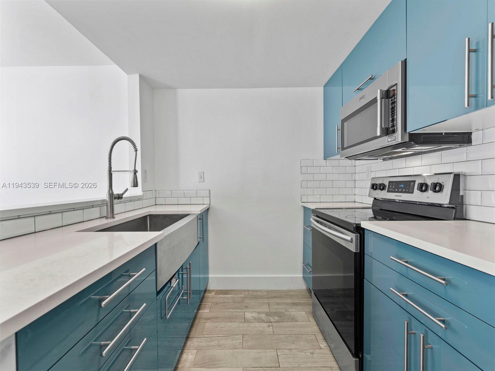 4560 Southwest 68th Ct Circle, Unit 619 Miami, FL 33155 - Photo 2 of 23 a kitchen with stainless steel appliances granite countertop a sink and a stove