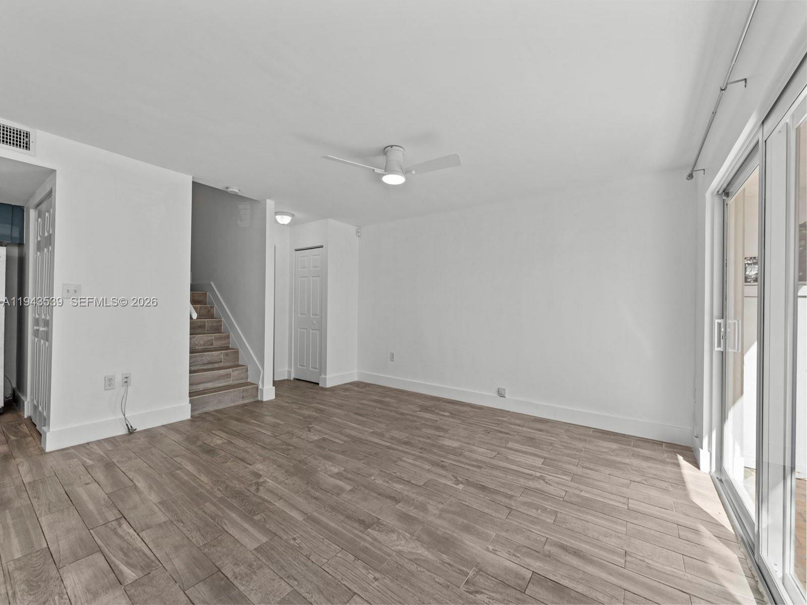 4560 Southwest 68th Ct Circle, Unit 619 Miami, FL 33155 - Photo 5 of 23 wooden floor in an empty room with a window