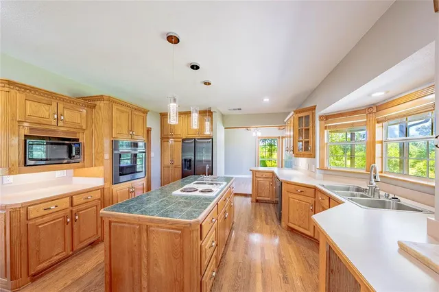 a kitchen with stainless steel appliances granite countertop a sink stove and refrigerator