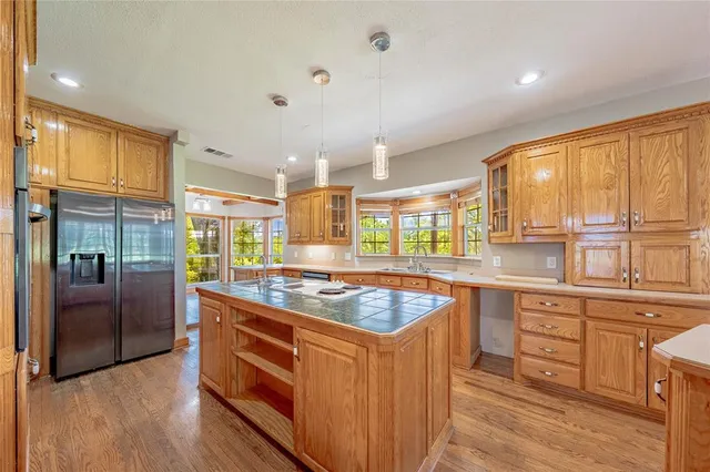 a kitchen with stainless steel appliances granite countertop a stove a sink and a refrigerator