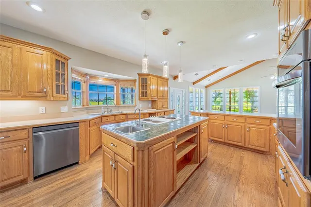 a kitchen with stainless steel appliances granite countertop a stove and a sink