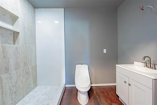 a bathroom with a toilet a sink and mirror