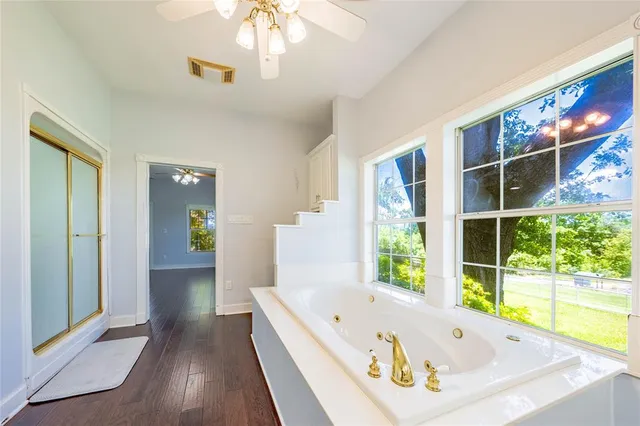 a bathroom with a bathtub and a window