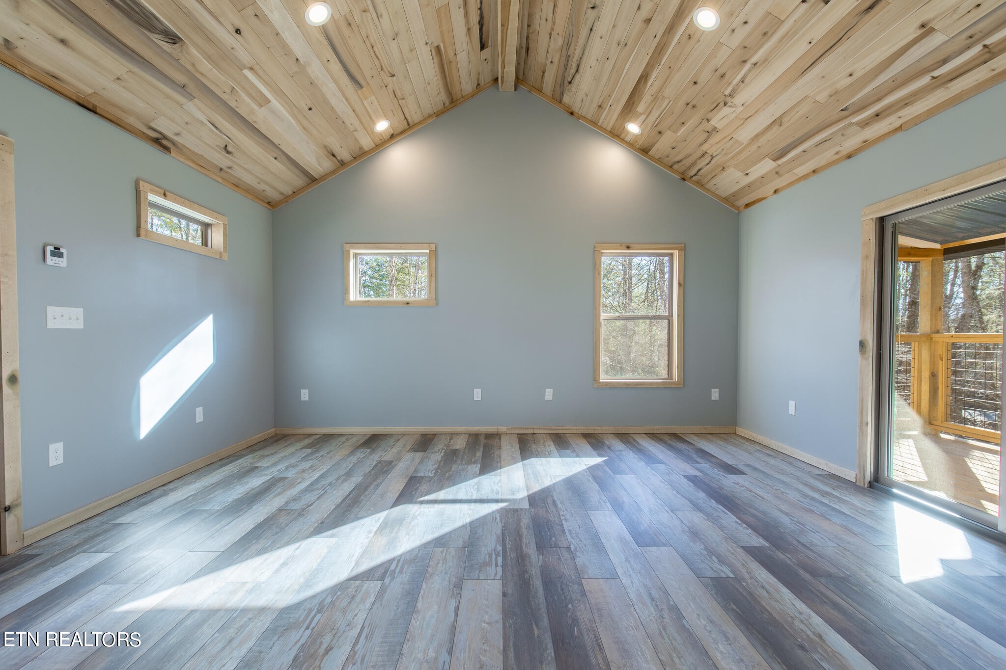 10795152 Shell Mountain Road Sevierville, TN 37876 - Photo 12 of 30 an empty room with wooden floor and windows
