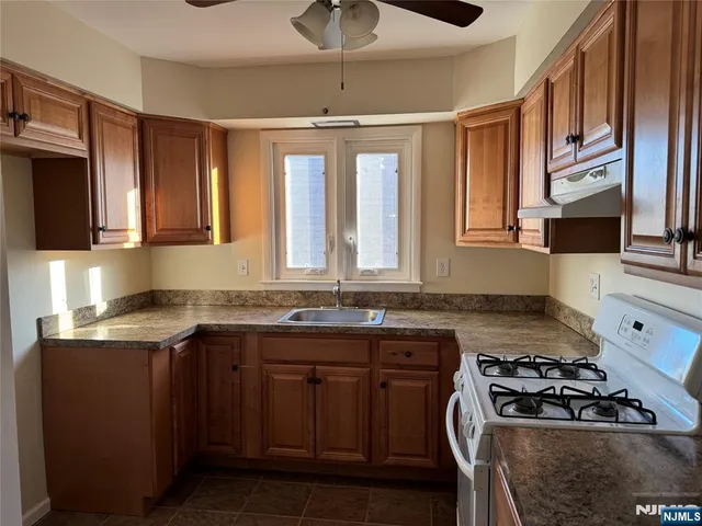 a kitchen with a stove a sink and a microwave