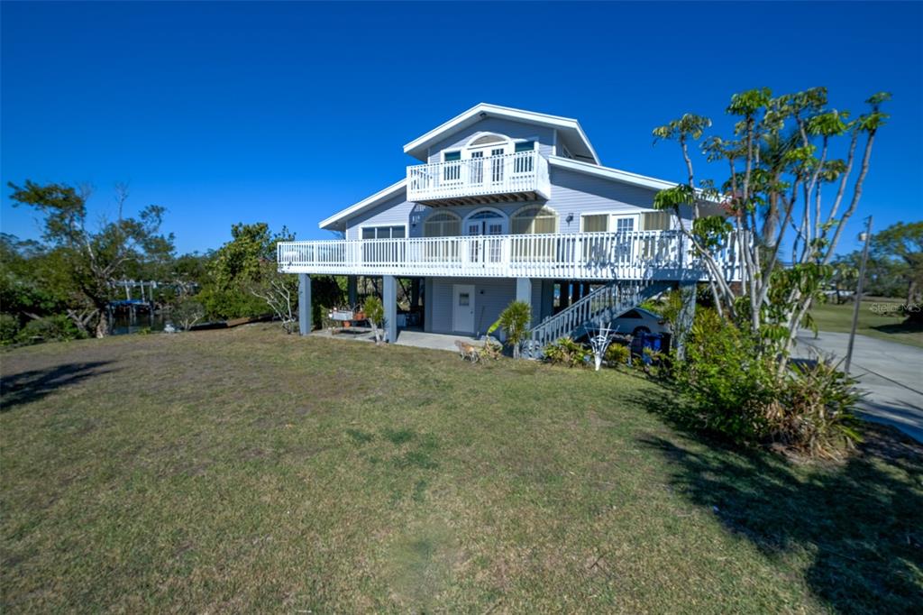 145 Burns Road Terra Ceia, FL 34250 - Photo 11 of 65 a front view of a house with a yard