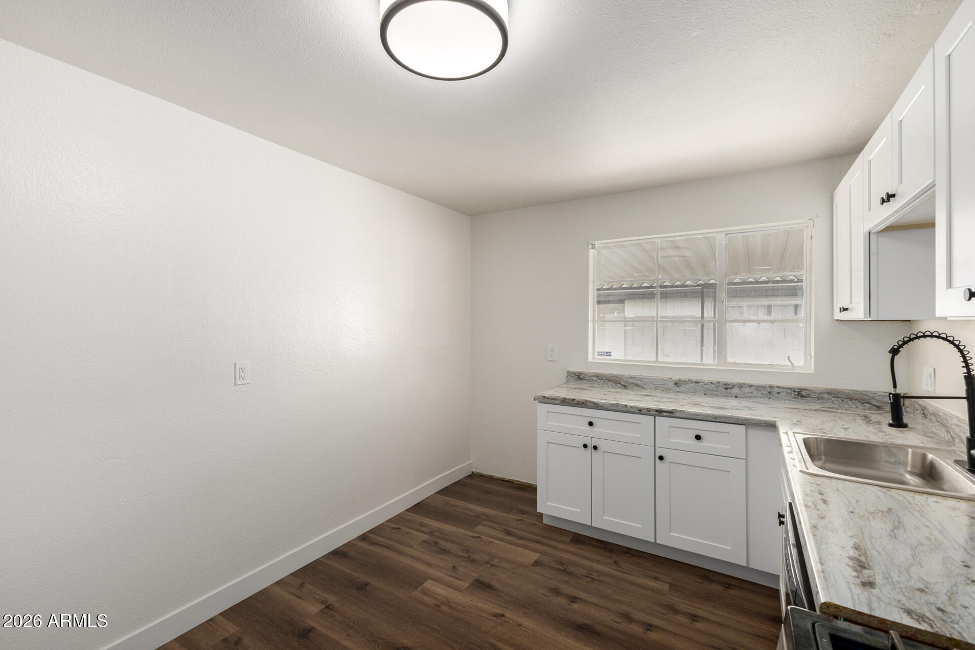 2114 West Rancho Drive Phoenix, AZ 85015 - Photo 11 of 29 a kitchen with sink cabinets and wooden floor