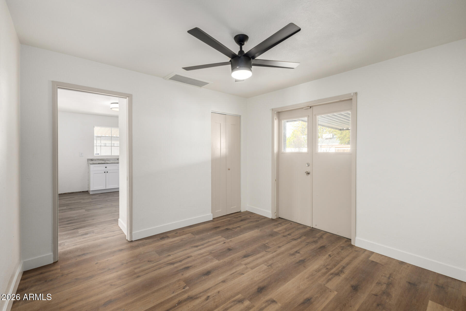 2114 West Rancho Drive Phoenix, AZ 85015 - Photo 12 of 29 wooden floor in an empty room with a window