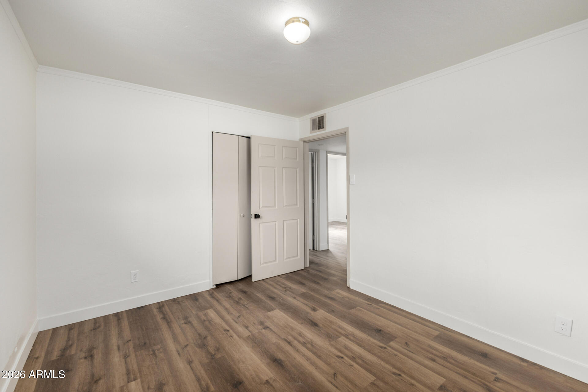 2114 West Rancho Drive Phoenix, AZ 85015 - Photo 16 of 29 a view of an empty room and wooden floor