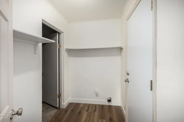a view of walk in closet with clothes
