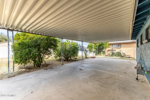 a view of a patio with table and chairs under an umbrella