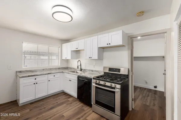 a kitchen with cabinets appliances and a counter space