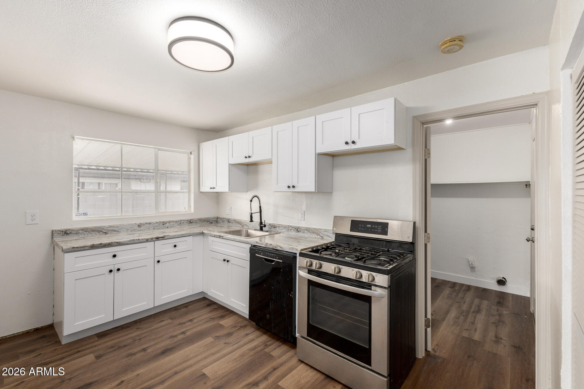 2114 West Rancho Drive Phoenix, AZ 85015 - Photo 9 of 29 a kitchen with cabinets appliances and a counter space