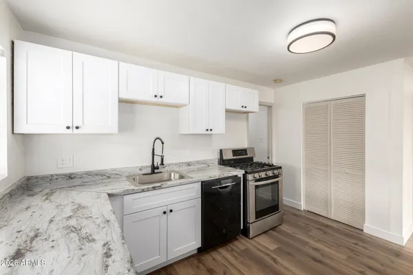 a kitchen with a sink stove and cabinets