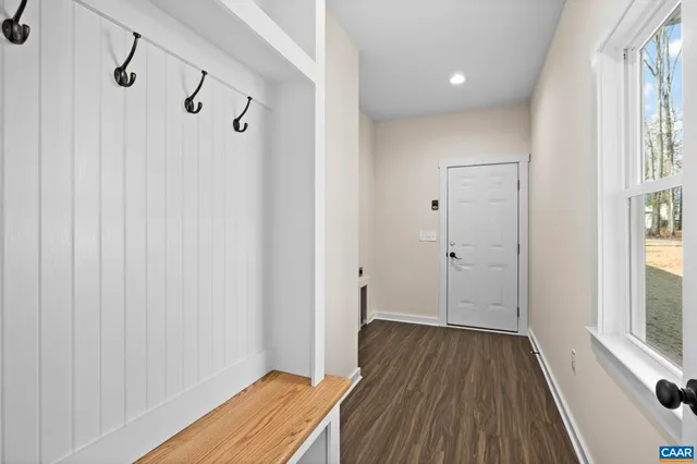 a view of a room with wooden floor and windows
