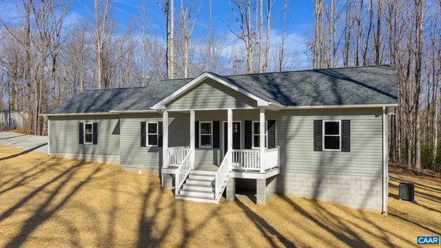 a view of a house with wooden floor and a yard