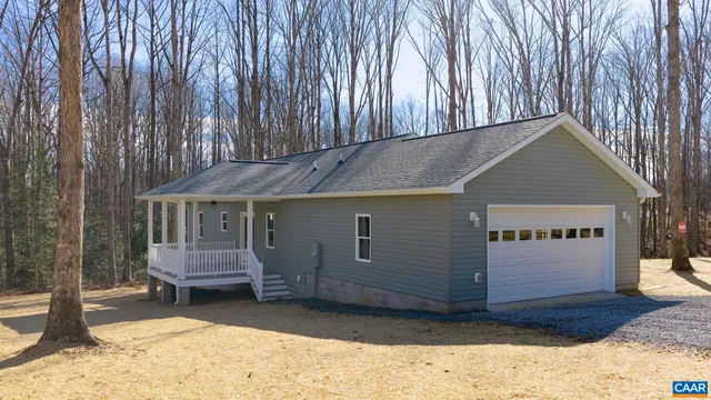 a view of a house with wooden fence