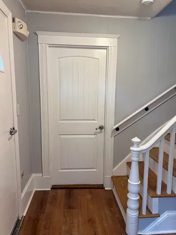 a view of walk in closet with wooden floor and window