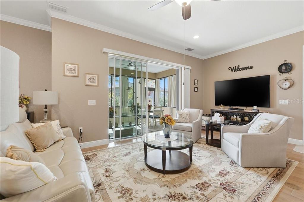 708 Teaberry Trail Polk City, FL 33868 - Photo 13 of 46 a living room with furniture and a flat screen tv
