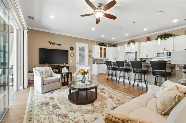 a kitchen with stainless steel appliances kitchen island granite countertop a refrigerator and a stove top oven